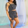 Black straight size female model with locs wearing black and white striped crop top and high waist shorts ethically handmade