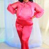Plus size black model with curly hair wearing pink organza blouse with neck tie + bell sleeves with red satin pants handmade