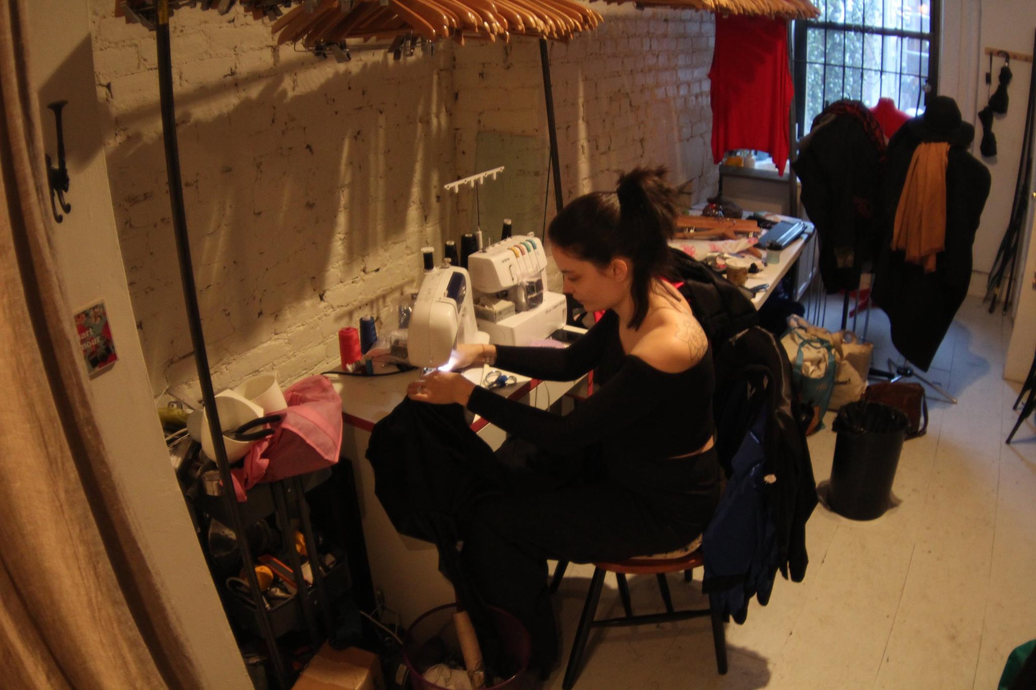 Mallorie Dunn of SmartGlamour sits at her sewing machine, making custom clothing