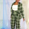 Straight size black model with short curly hair wearing green plaid suit and cream satin camisole, ethically handmade in NYC