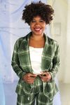 Straight size black model with short curly hair wearing green plaid suit and cream satin camisole, ethically handmade in NYC