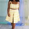Black plus size female model with curls wearing yellow and white check crop top and high waist shorts ethically handmade
