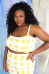 Black plus size female model with curls wearing yellow and white check crop top and high waist shorts ethically handmade