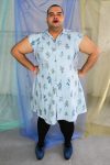Confident latinx non binary plus size model wearing a pinstripe floral button front collared shirt dress, made in NYC