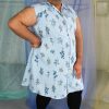 Smiling latinx non binary plus size model wearing a pinstripe floral button front collared shirt dress, ethically made in NYC