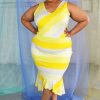 Yellow v-neck striped dress with pencil skirt and ruffle hemline modeled by plus size black bald model.