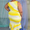 Back view of plus size model wearing yellow Nadine striped jersey dress with a v-neck and ruffle at bottom of fitted skirt.