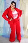 Confident plus size tall black model with curly short hair wearing red suit and pink satin camisole, ethically made in NYC