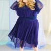 White blonde plus size model wearing navy classic blue mesh skirt smiling and happy, with matching long sleeve ruffle top