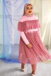 Hijabi plus size model wearing dusty rose pink mesh skirt twirling and happy, with matching long sleeve ruffle top