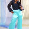 Straight size black model with braid wearing navy organza blouse and seafoam blue green satin wide leg pants, handmade in NYC